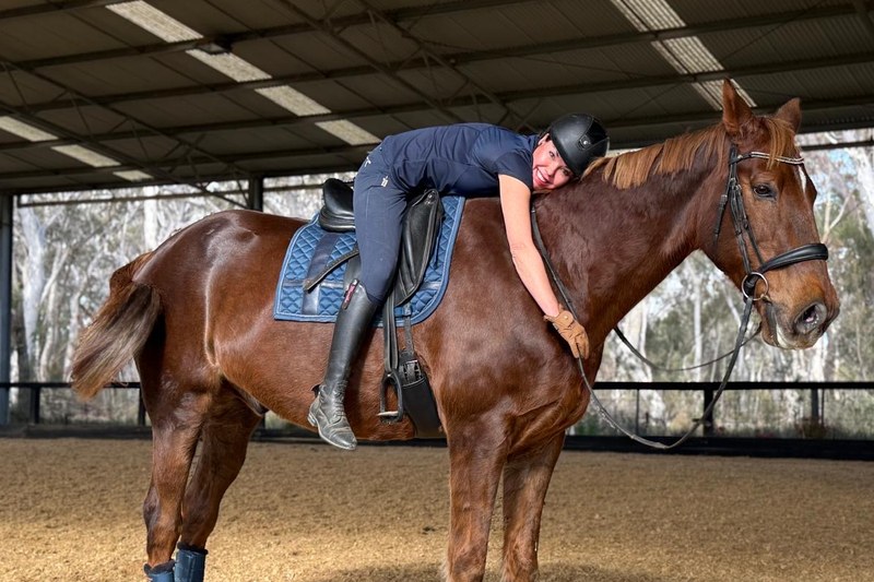 Monika hugging her horse Paddy after a breakthrough lesson